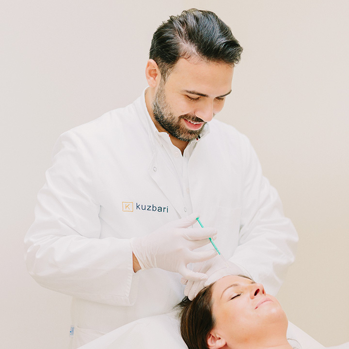 Dr. Shawqi Arafat giving an injectable treatment at the Kuzbari Centre